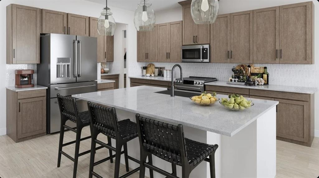 This rendering shows a kitchen with wood cabinets, a white island, and stainless steel appliances — 7895 INTERSTELLAR AVENUE, SARASOTA, FL