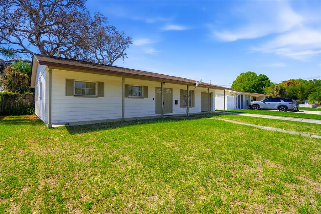 A single-story white house with a covered front porch sits on a grassy lot — 3312 W BURKE ST, TAMPA, FL