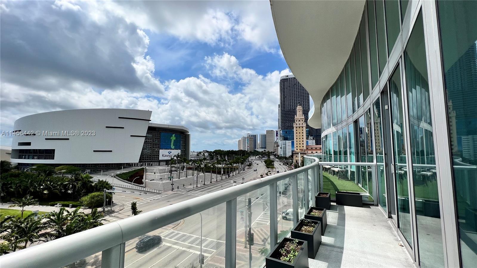 A balcony with glass railings overlooks a city street and the Kaseya Center arena — 888 Biscayne  Blvd, Miami FL 33132, MIAMI, FL