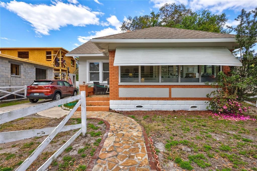 A single-story house with a brick facade, a front porch, and a stone walkway — 2521 4TH STREET S, ST PETERSBURG, FL