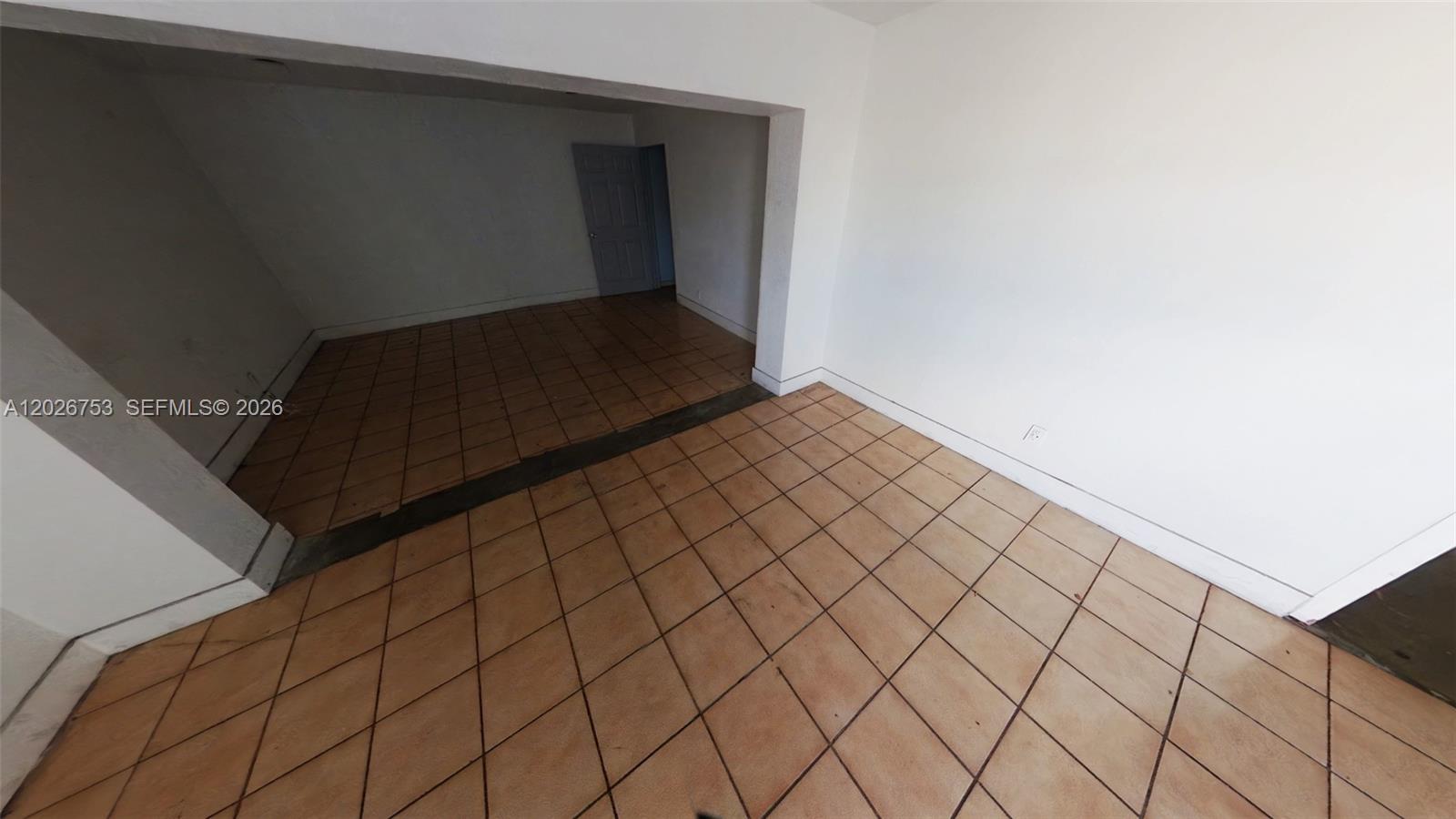 An interior room features white walls and brown square floor tiles set on a diagonal — 1055 SE 9th Ct # 65, Hialeah FL 33010, HIALEAH, FL