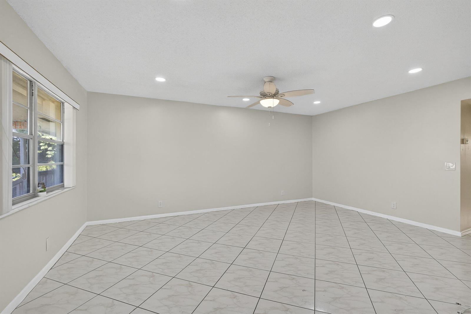 An empty room with light-colored walls, a ceiling fan, and diagonal tile flooring — 149 Hastings I, West Palm Beach FL 33417, WEST PALM BEACH, FL