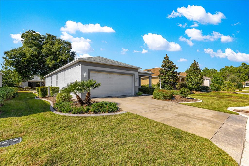 A single-story house with a gray exterior, a two-car garage, and a concrete driveway — 8546 SW 79TH AVENUE, OCALA, FL
