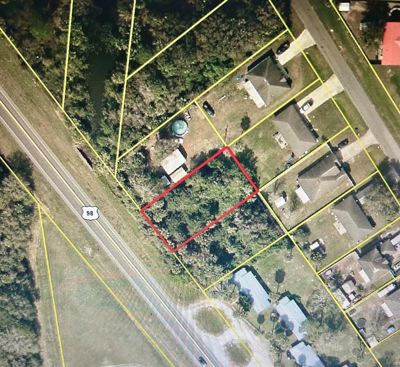 An aerial map view shows a rectangular vacant lot outlined in red near a highway — 2660 Hwy 98 N, FL 34972, FL