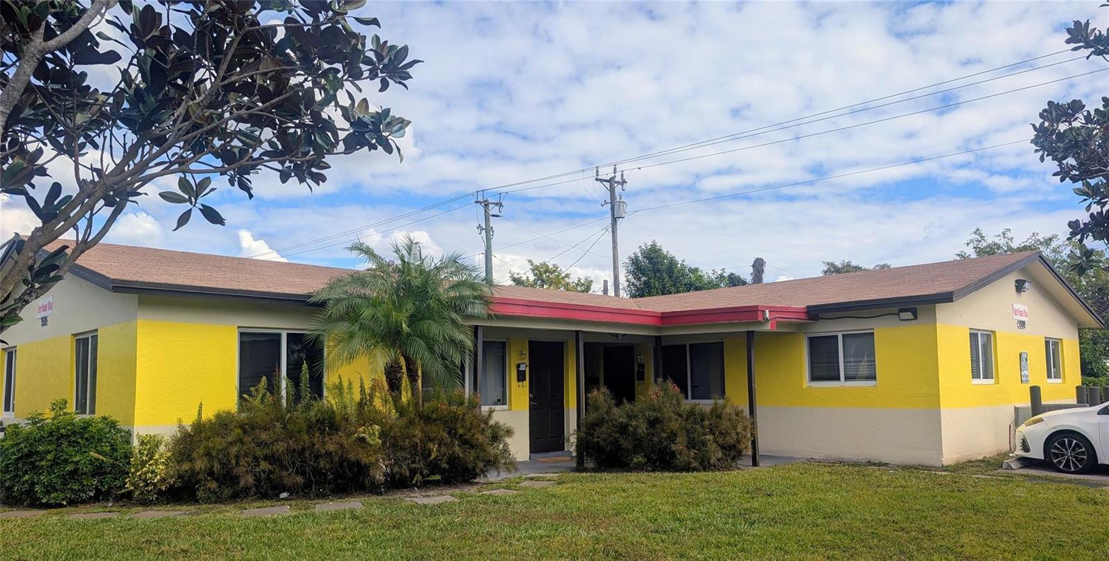 A single-story yellow and beige building with a brown roof and a small palm tree — 1500 NW 58th Terrace, Sunrise FL 33313, SUNRISE, FL