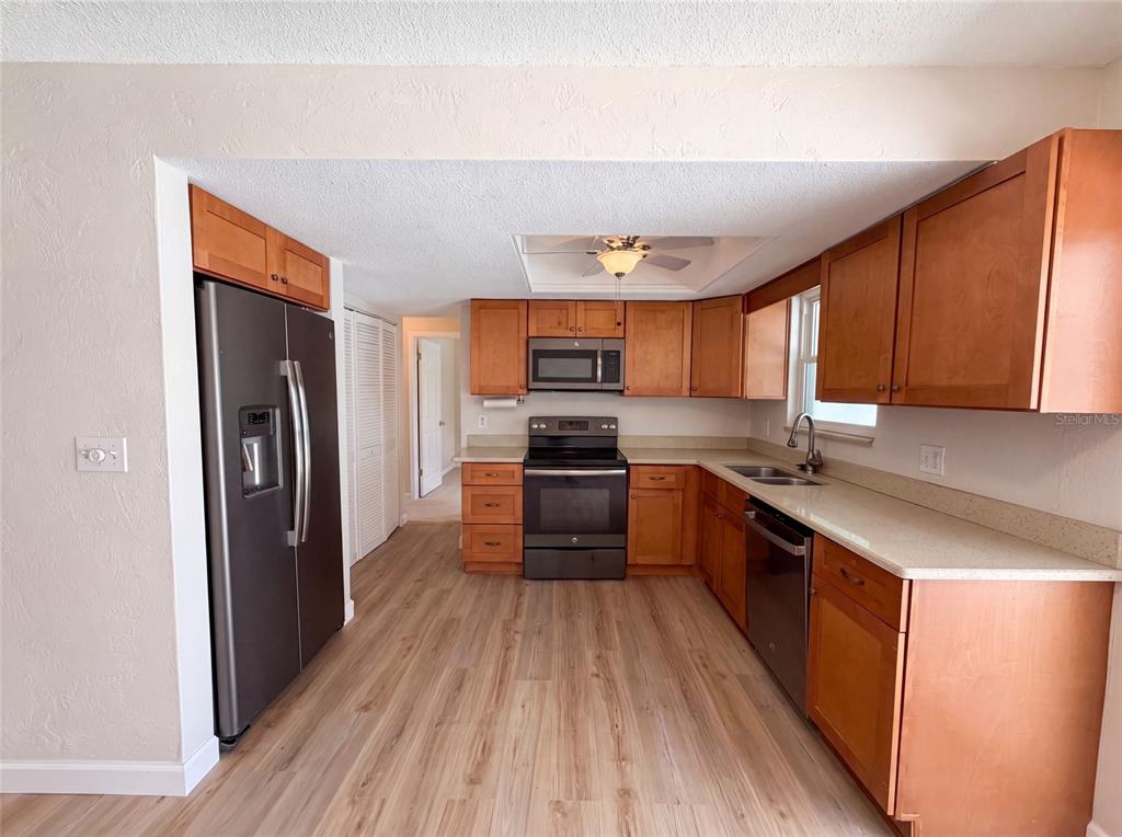 A kitchen with wood cabinets, stainless steel appliances, and light-colored countertops — 624 SHERMAN ROAD, SOUTH DAYTONA, FL