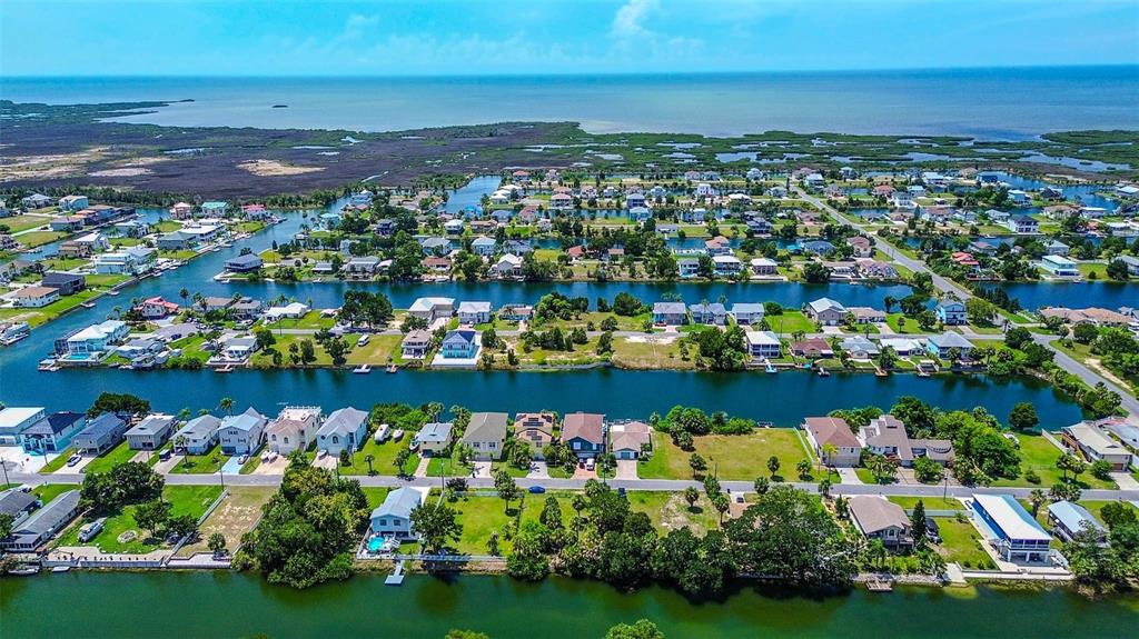 An aerial view of a coastal residential neighborhood featuring houses situated along multiple parallel canals — 0 SEA GRAPE DRIVE Lot 10, HERNANDO BEACH, FL