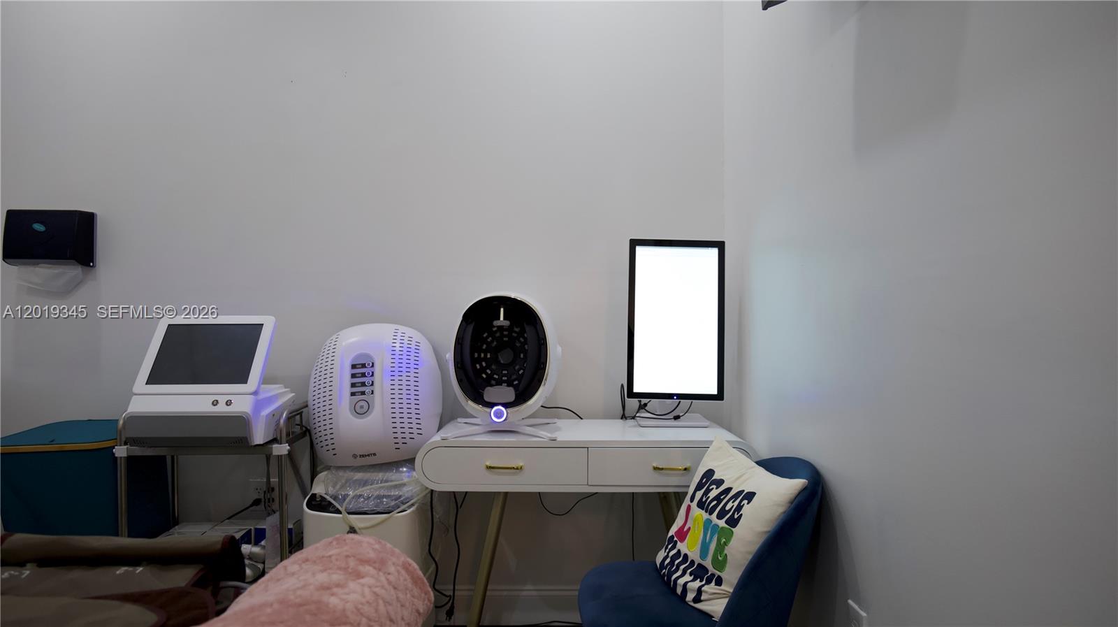 A treatment room contains a desk with medical aesthetic equipment and a blue chair — 8684 Griffin Rd, Cooper City FL 33328, COOPER CITY, FL