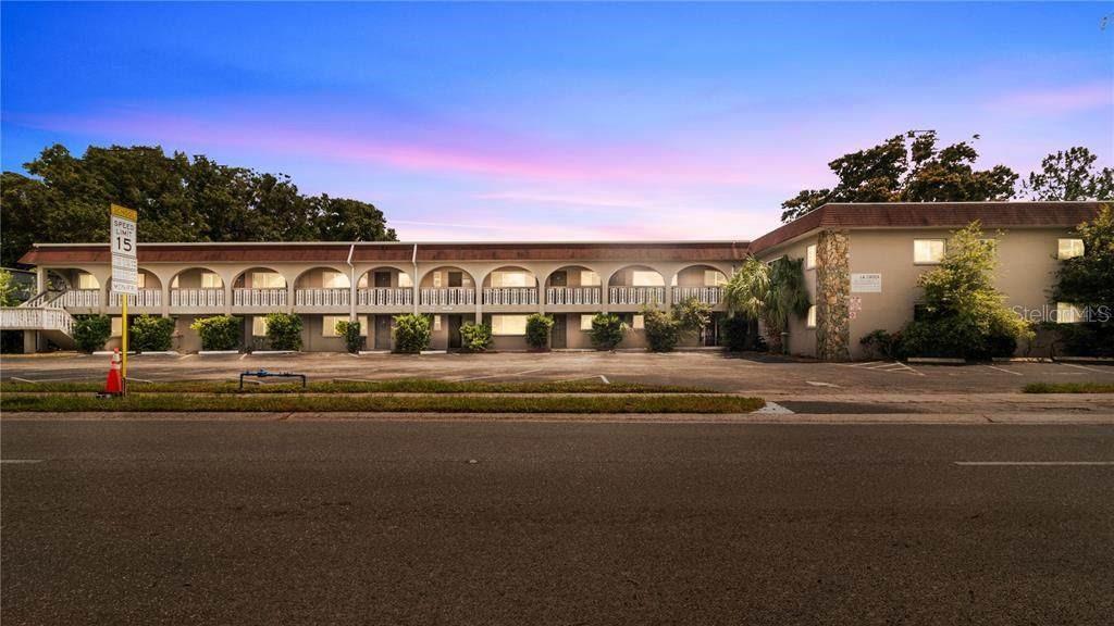 A two-story motel building with an arched exterior walkway and a paved parking lot — 5900 22ND AVENUE N, ST PETERSBURG, FL
