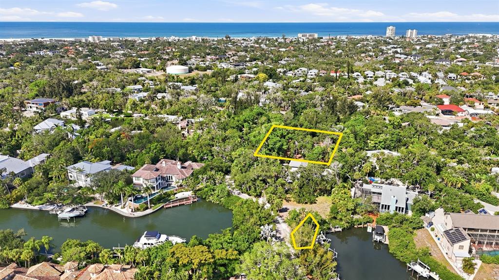 An aerial view shows two highlighted parcels of land surrounded by trees and waterfront homes — 1325 HIDDEN HARBOR WAY, SARASOTA, FL