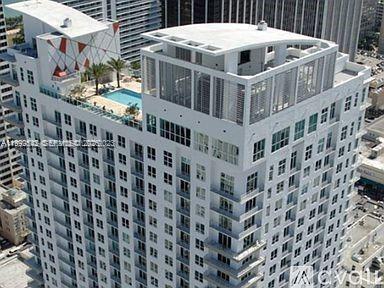 An aerial view of a high-rise building featuring a rooftop pool and deck area — 133 NE 2nd Ave # 3410, Miami FL 33132, MIAMI, FL