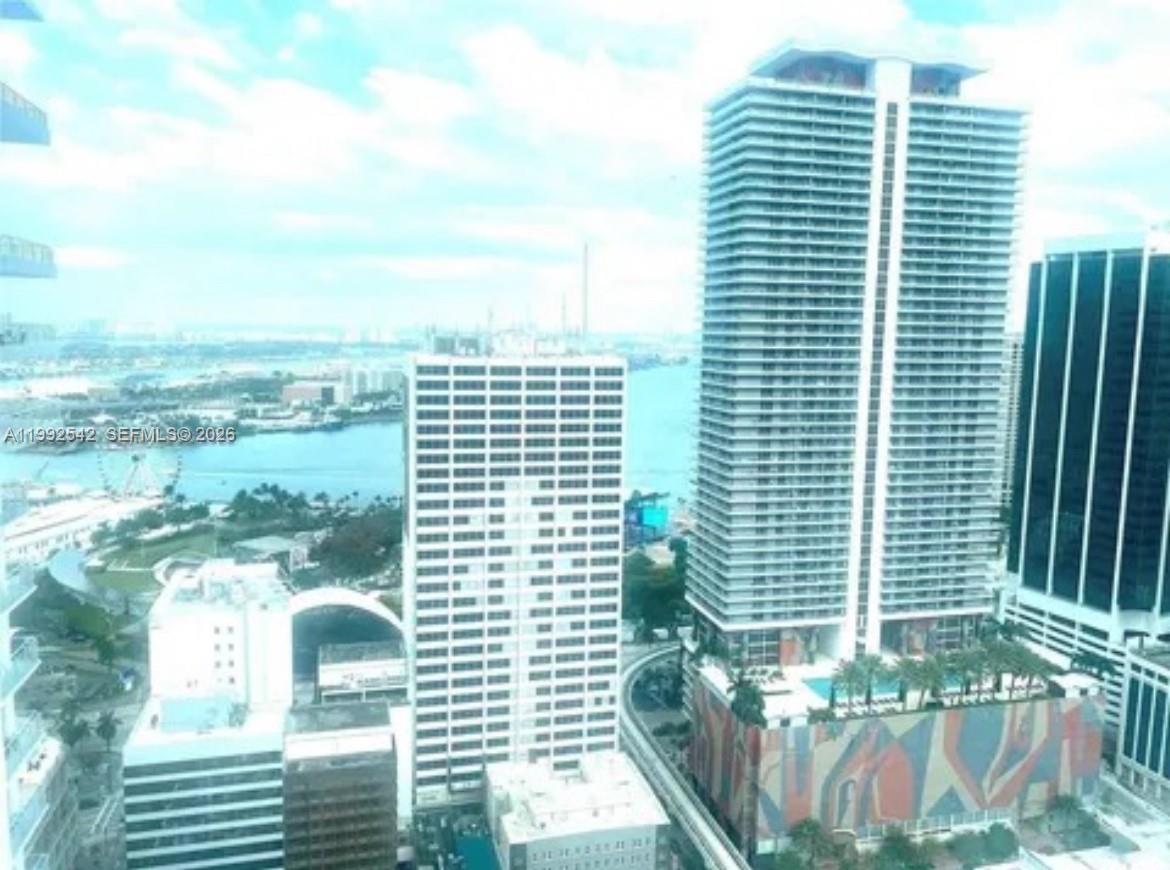 An elevated view of several high-rise buildings overlooking a bay with a Ferris wheel — 133 NE 2nd Ave # 3410, Miami FL 33132, MIAMI, FL