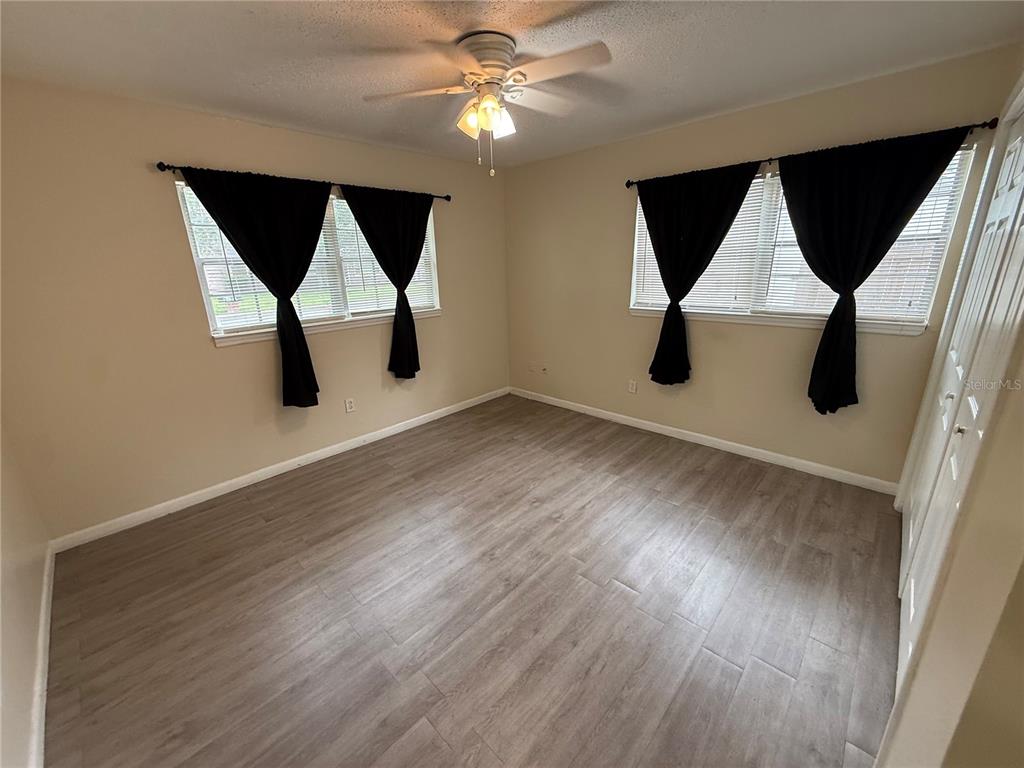 A kitchen features a stainless steel stove, granite countertops, and a tiled backsplash — 5515 NW 27TH TERRACE, GAINESVILLE, FL