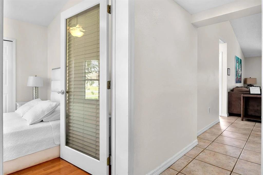 A single-story house with gray siding, white trim, a front walkway, and a two-car garage — 714 CARIBOU DRIVE, POINCIANA, FL