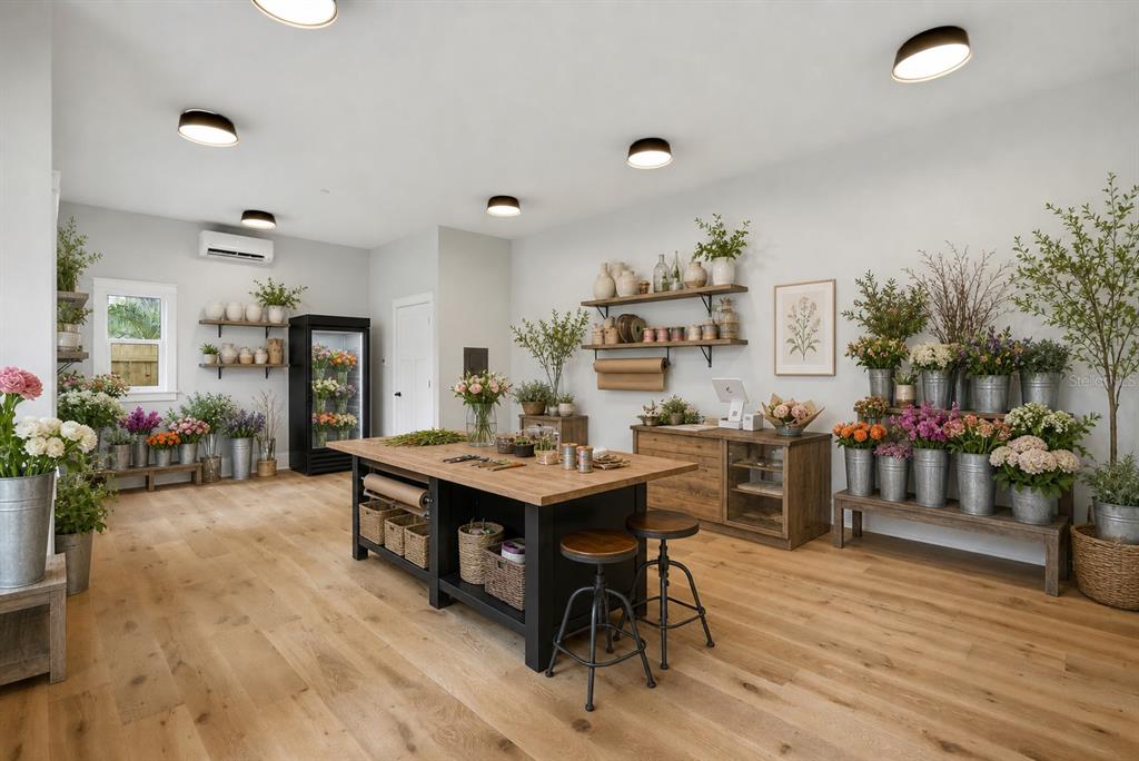 A bright floral shop features wood flooring, a central work island, and tiered flower displays — 2540 1ST AVENUE N, ST PETERSBURG, FL