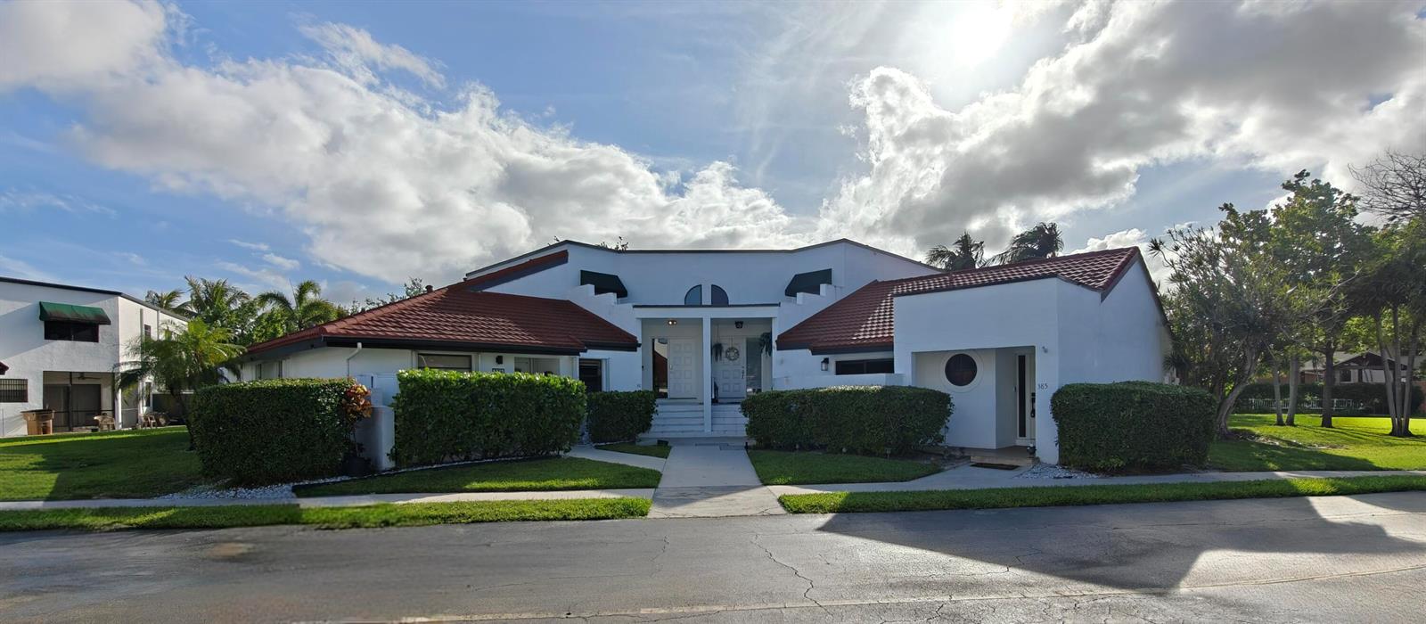 A white, single-story duplex with a red tile roof and manicured hedges — 385 NW 36th Avenue, Deerfield Beach FL 33442, DEERFIELD BEACH, FL