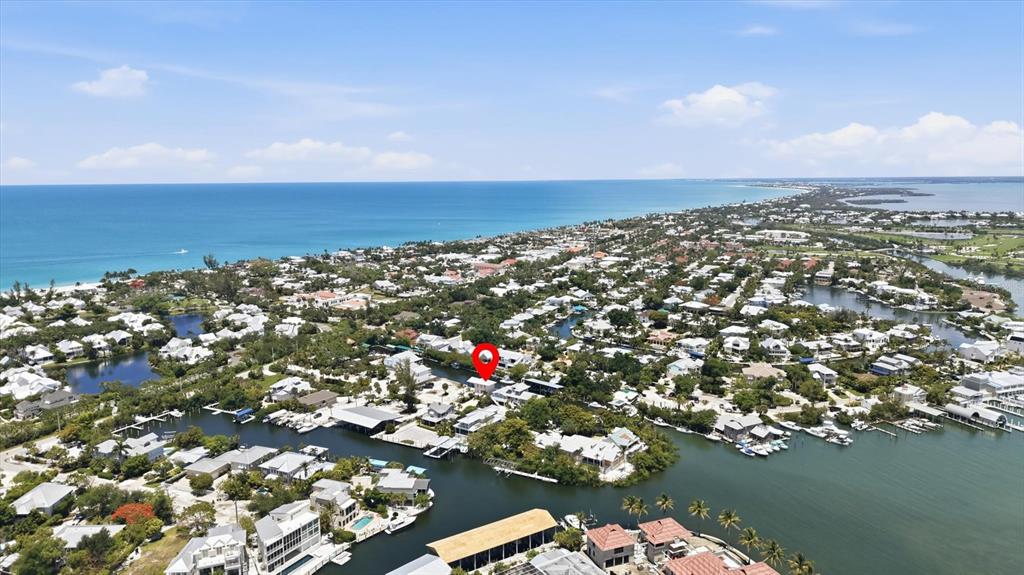 An aerial view shows a residential neighborhood with canals and a red location marker — 171 DAMFIWILL STREET, BOCA GRANDE, FL