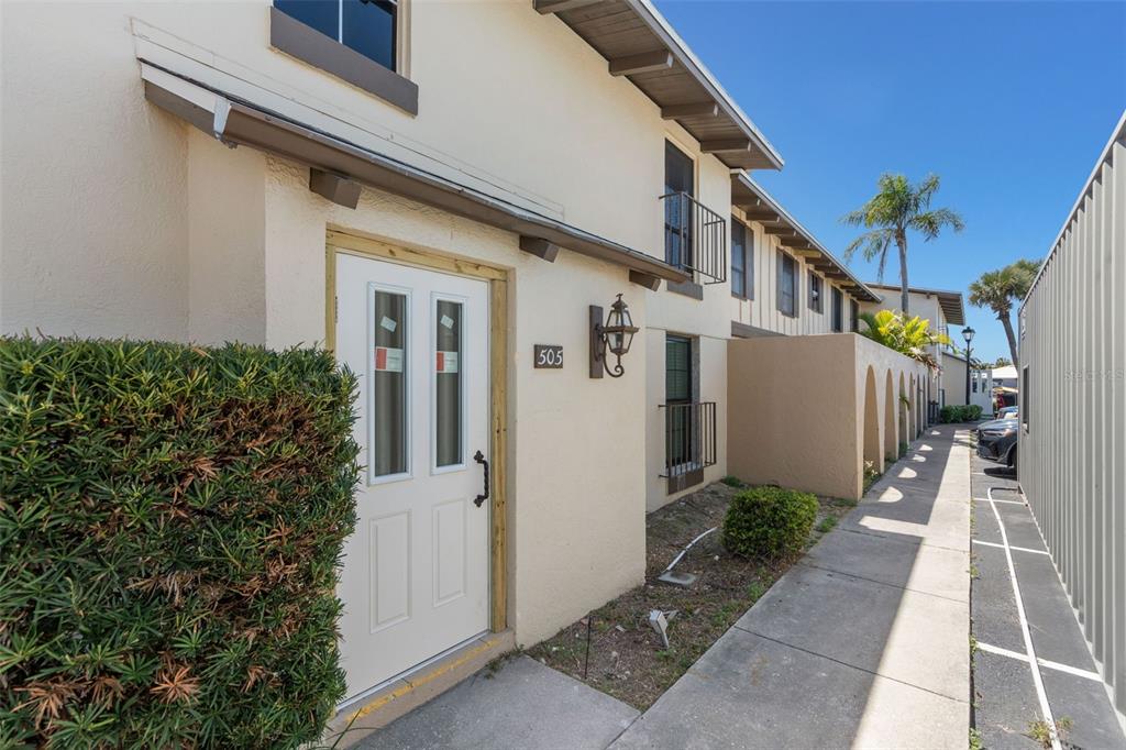 A dining area with tiled floors, a chandelier, and a partial wall opening to the kitchen — 505 PLAZA SEVILLE COURT UNIT 11, TREASURE ISLAND, FL