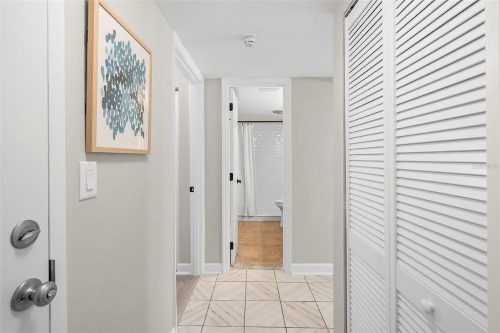 A kitchen features white cabinets, marble-patterned countertops, stainless steel appliances, and a corner sink — 505 PLAZA SEVILLE COURT UNIT 11, TREASURE ISLAND, FL