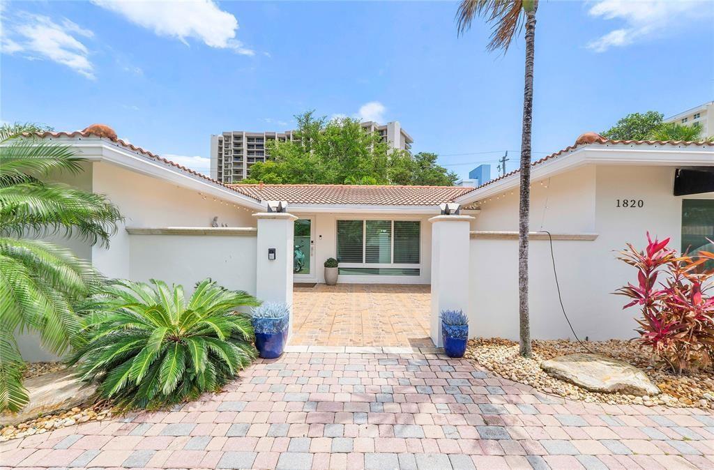 A single-story house features a paved driveway, a gated courtyard entrance, and a tiled roof — 1820 Bel Air Avenue, Pompano Beach FL 33062, POMPANO BEACH, FL