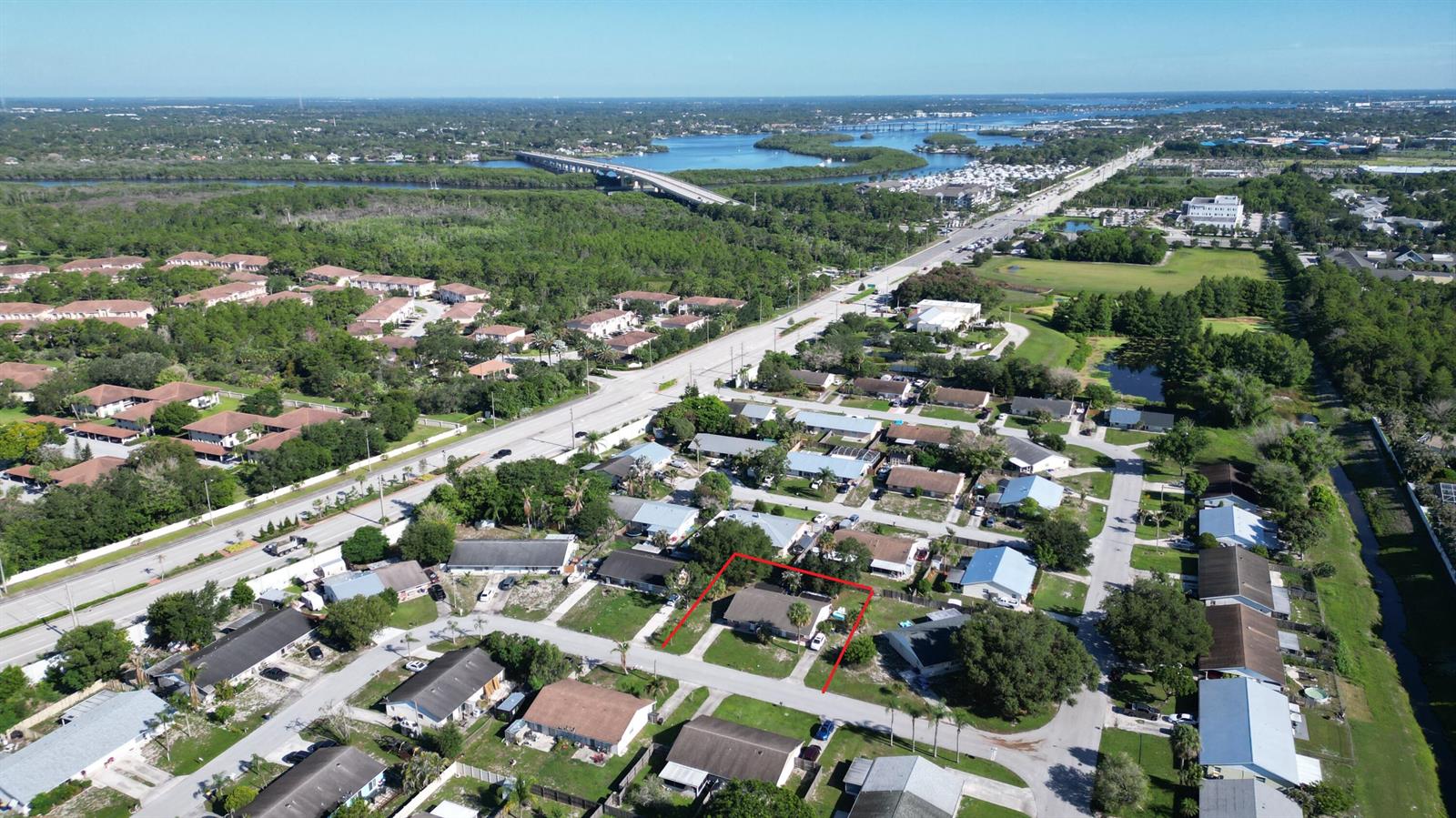 An aerial view shows a single-story house outlined in red within a suburban neighborhood — 85 & 95 SE Millwood Terrace, Stuart FL 34997, STUART, FL