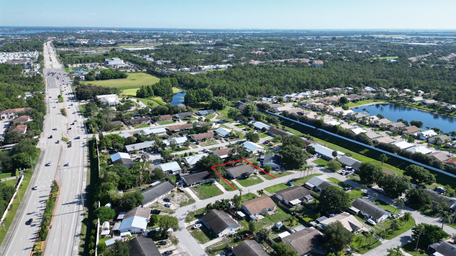 An aerial view shows a residential neighborhood with a single-story house outlined in red — 85 & 95 SE Millwood Terrace, Stuart FL 34997, STUART, FL