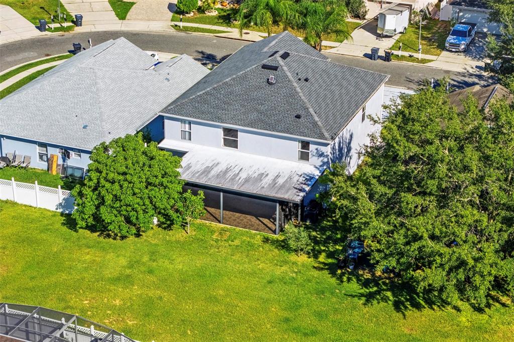 An aerial view shows the back of a two-story house with a screened-in patio — 420 BLAKE AVENUE, DAVENPORT, FL