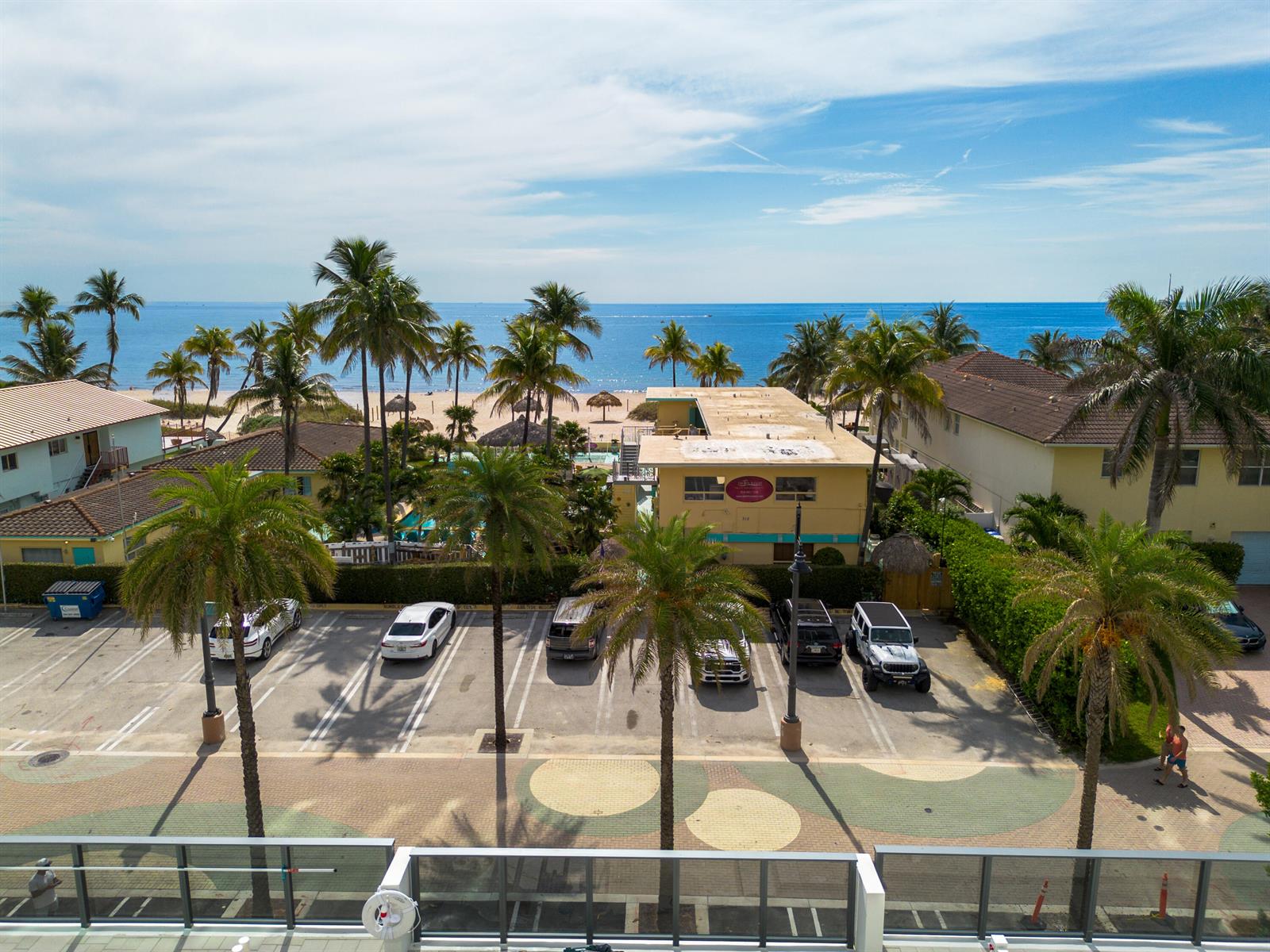 An elevated view shows a parking lot with palm trees in front of a beach — 305 Briny Avenue # 406, Pompano Beach FL 33062, POMPANO BEACH, FL