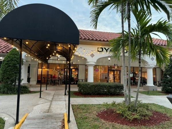 A black arched awning covers a walkway leading to a commercial building with arched entrances — TBA BOYNTON BEACH BOULEVARD, BOYNTON BEACH, FL