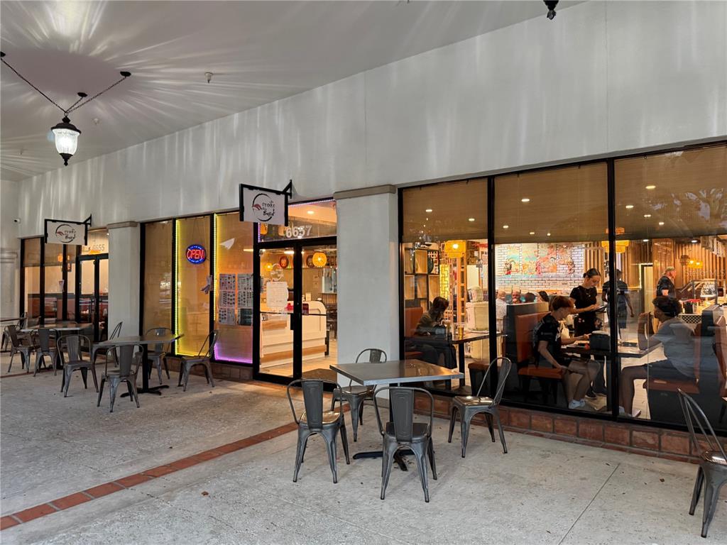 An exterior view of a restaurant storefront with outdoor seating and large glass windows — TBA BOYNTON BEACH BOULEVARD, BOYNTON BEACH, FL