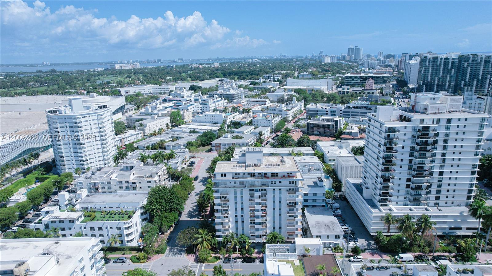 An aerial view shows a dense urban neighborhood with multiple high-rise apartment buildings and greenery — 245 18th St # 605, Miami Beach FL 33139, MIAMI BEACH, FL