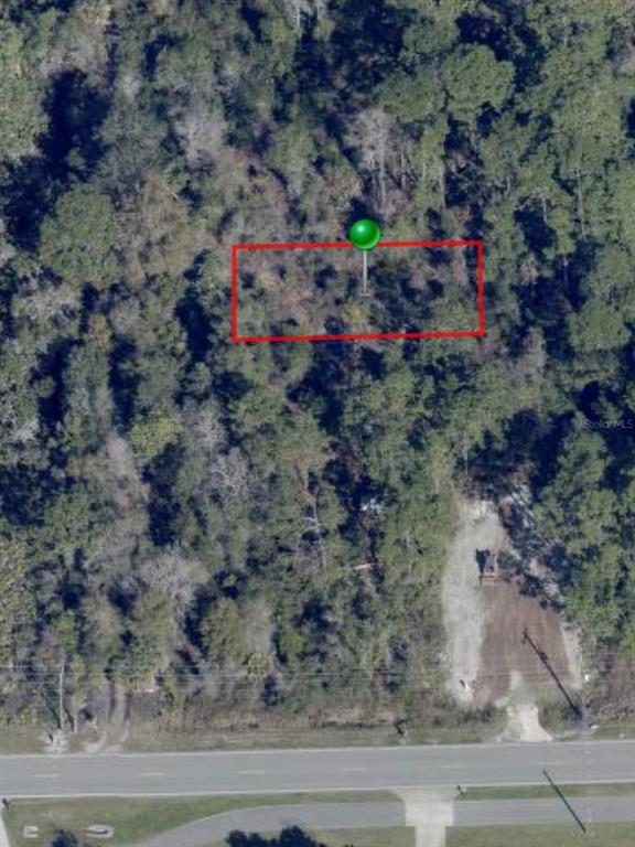 An aerial view shows a rectangular plot of land marked with a green pin — OSTEEN MAYTOWN ROAD, OSTEEN, FL