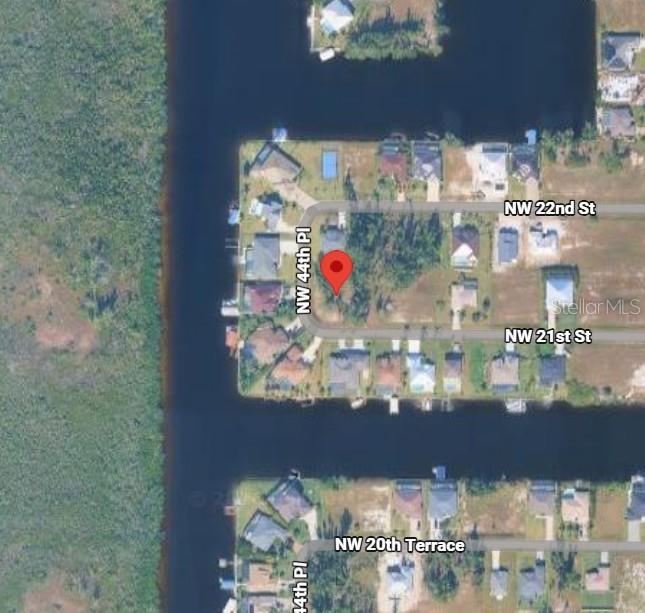 This is an aerial map view of a residential lot located on a canal — 4409 NW 21ST STREET, CAPE CORAL, FL