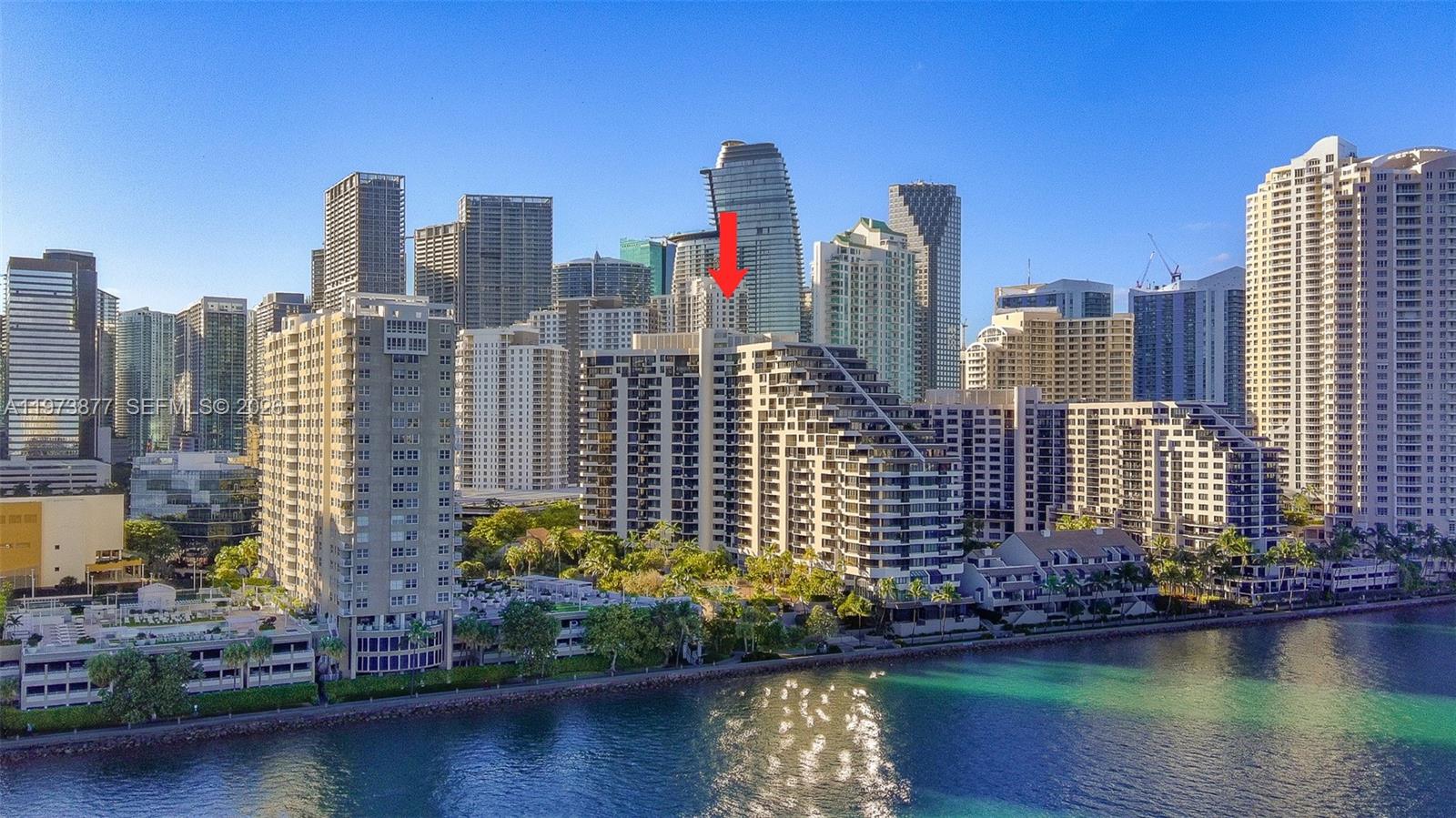 An aerial view of a waterfront high-rise residential complex in a dense city skyline — 520 Brickell Key Dr # A1007, Miami FL 33131, MIAMI, FL
