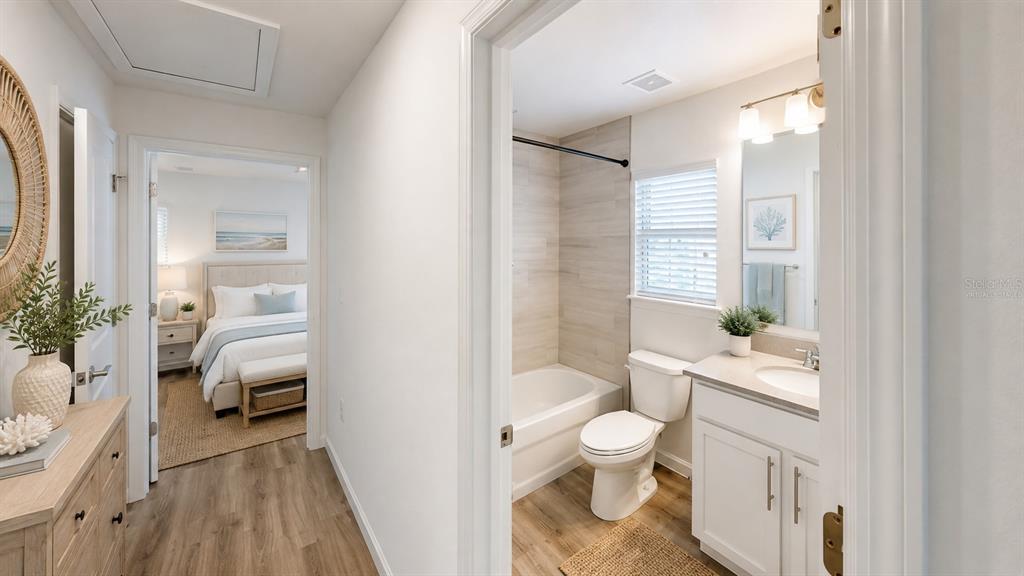 A hallway leads to a bedroom and a bathroom with a tub-shower and vanity — 22 ZEBULAHS TRAIL, PALM COAST, FL
