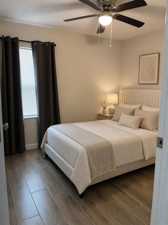 A bedroom features a bed with neutral bedding, a ceiling fan, and wood-look tile flooring — 15200 SW 60TH CIRCLE, OCALA, FL