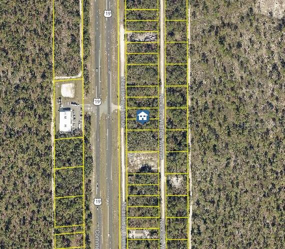 This aerial map shows a residential lot highlighted among undeveloped land and nearby roads — LOT 16 NECKLACE WARBLER AVENUE, WEEKI WACHEE, FL