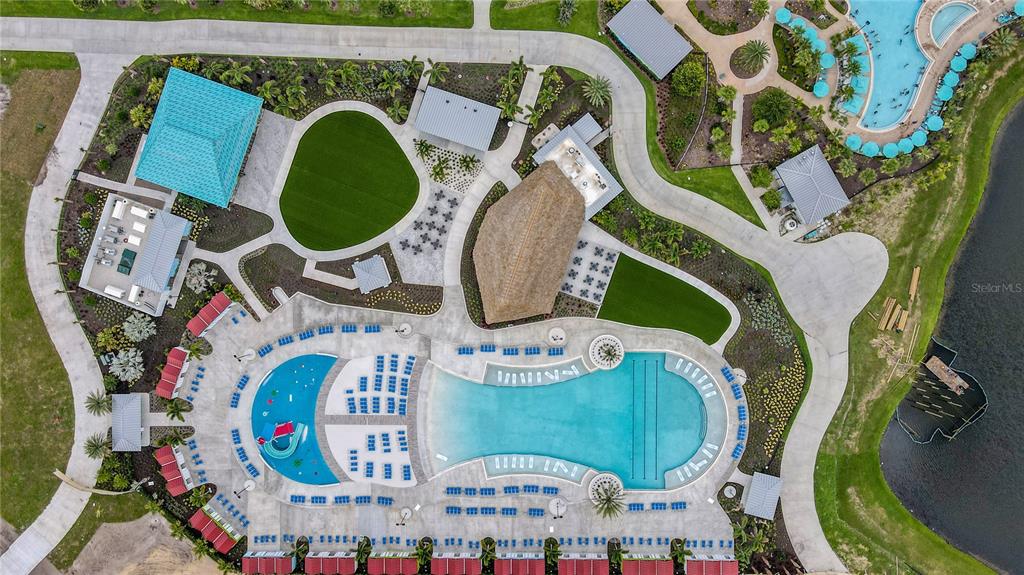 An aerial view shows a resort-style swimming pool complex with cabanas, landscaping, and walking paths — 3151 SUNSET WALK DRIVE UNIT 112, KISSIMMEE, FL