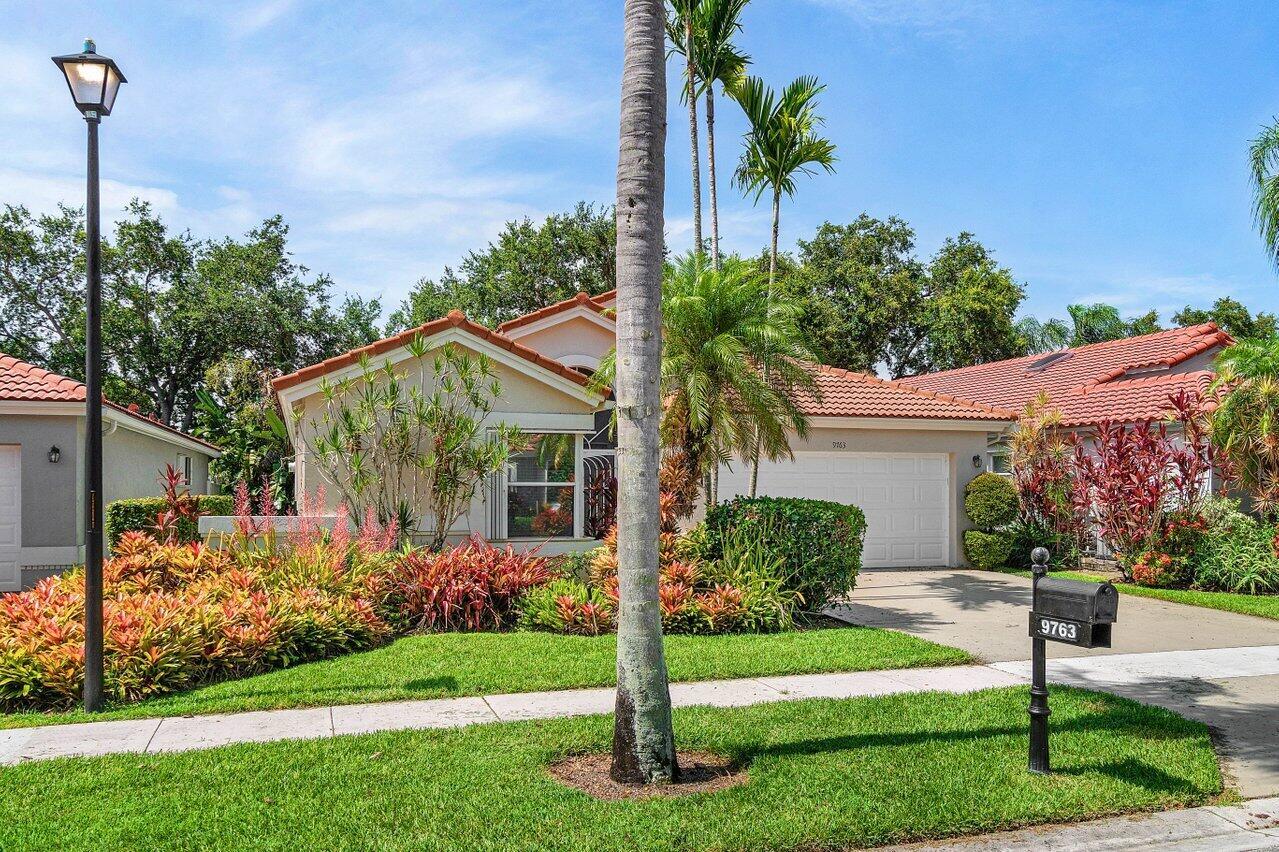 A single-story house with a red tile roof, a two-car garage, and lush landscaping — 9763 Harbour Lake Circle S, Boynton Beach FL 33437, BOYNTON BEACH, FL