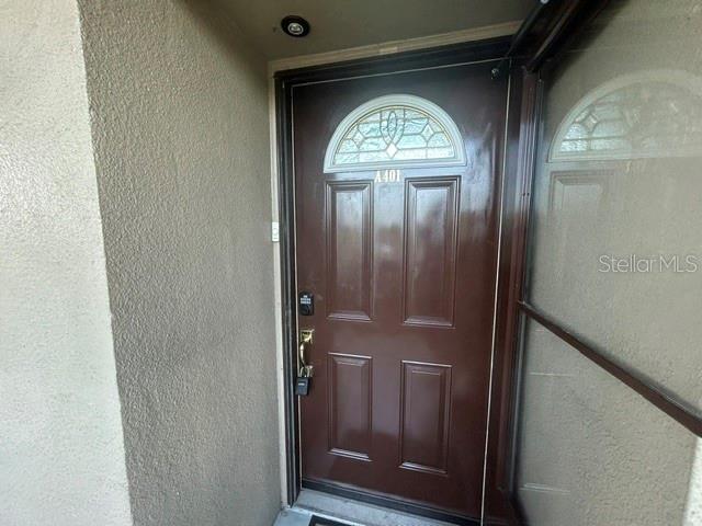 A dark brown front door with a semi-circular window and a digital lock — 1243 S MARTIN LUTHER KING JR AVENUE UNIT A401, CLEARWATER, FL