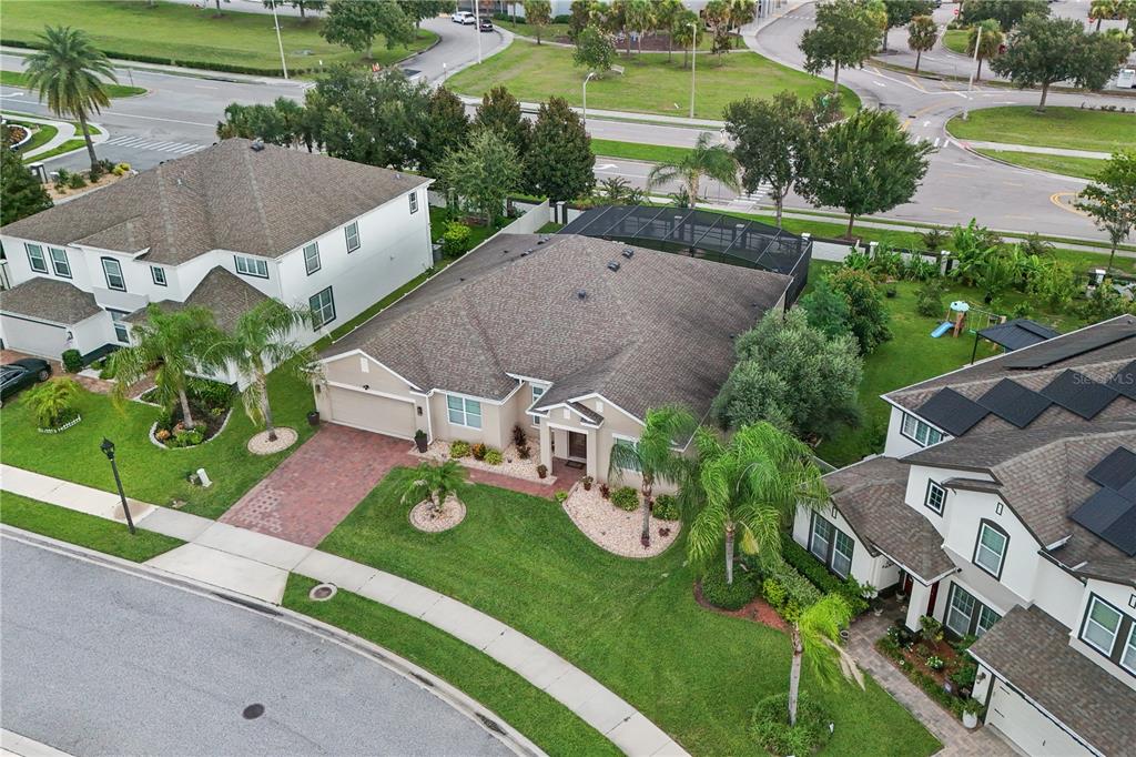 An aerial view shows a single-story suburban house with a screened pool and paved driveway — 14343 BLACK LAKE PRESERVE STREET, WINTER GARDEN, FL