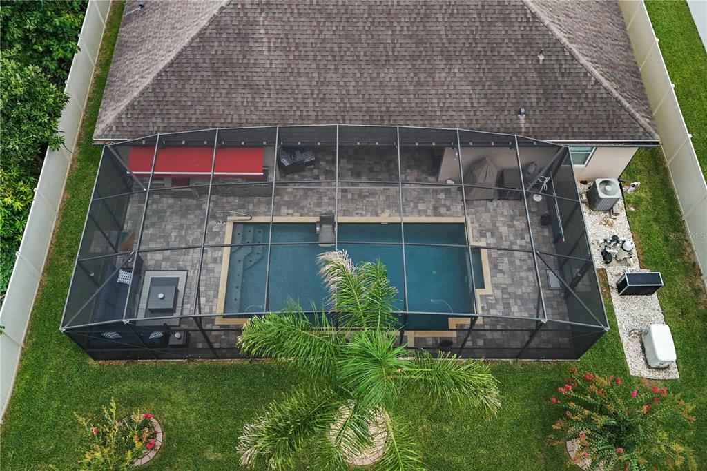 An aerial view shows a backyard swimming pool enclosed by a screened lanai — 14343 BLACK LAKE PRESERVE STREET, WINTER GARDEN, FL