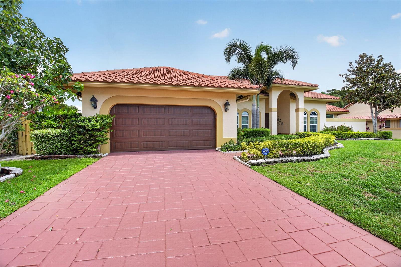 A single-story house with a red tile roof, brown garage door, and red paved driveway — 2931 NW 25th Way, Boca Raton FL 33434, BOCA RATON, FL