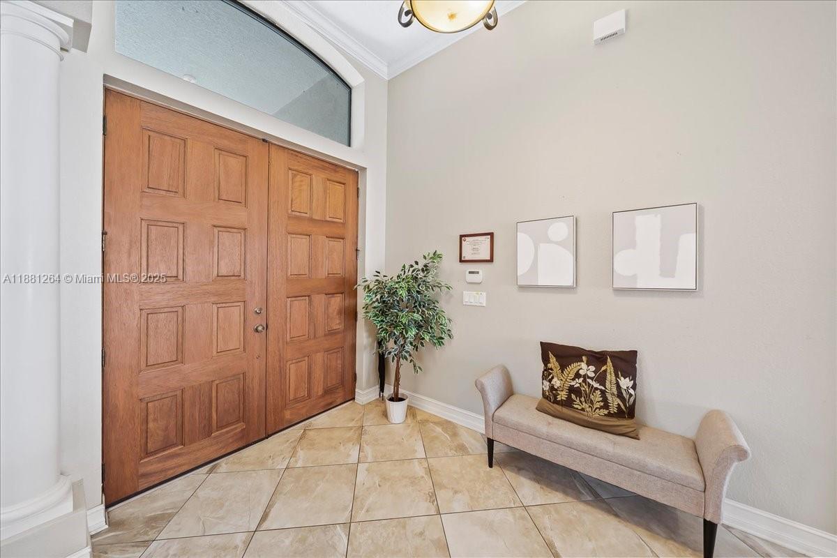 An entryway features a double wood door, tile flooring, a bench, and wall art — 6340 US 1, Cocoa FL 32927, COCOA, FL