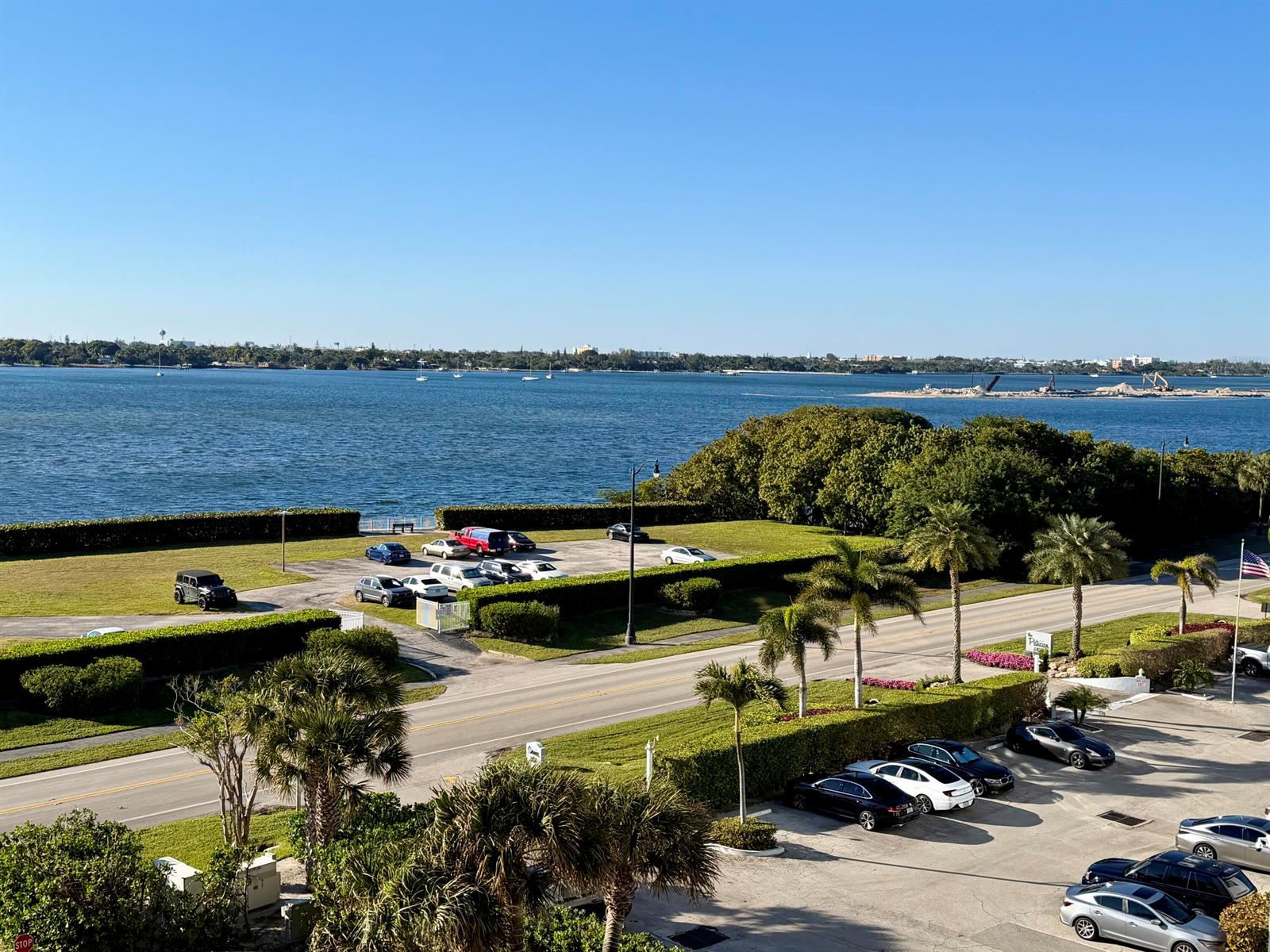 An elevated view of a parking lot, a road, palm trees, and a large body of water — 3460 S Ocean Boulevard # 5110, Palm Beach FL 33480, PALM BEACH, FL