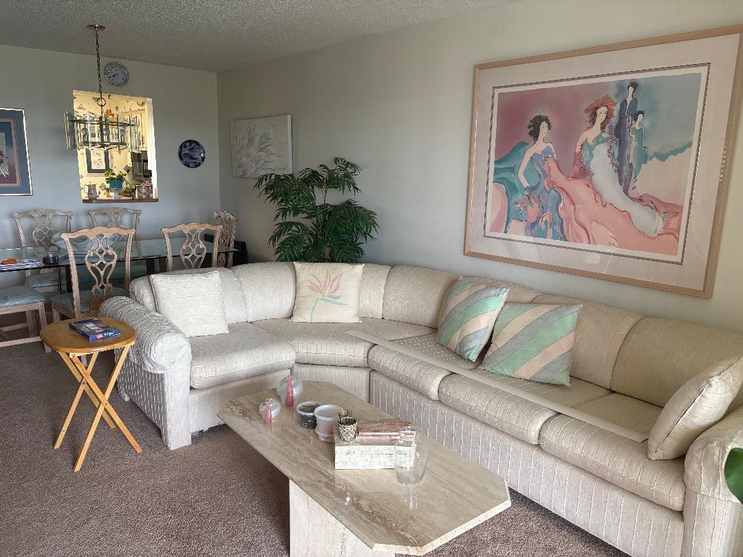 A living room features a large beige sectional sofa, a marble coffee table, and wall art — 7301 NW 1st Street # 406, Margate FL 33063, MARGATE, FL