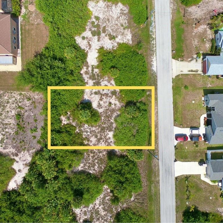An aerial view shows a rectangular vacant lot outlined in yellow next to a road — 14132 UNION HALL AVENUE, PORT CHARLOTTE, FL