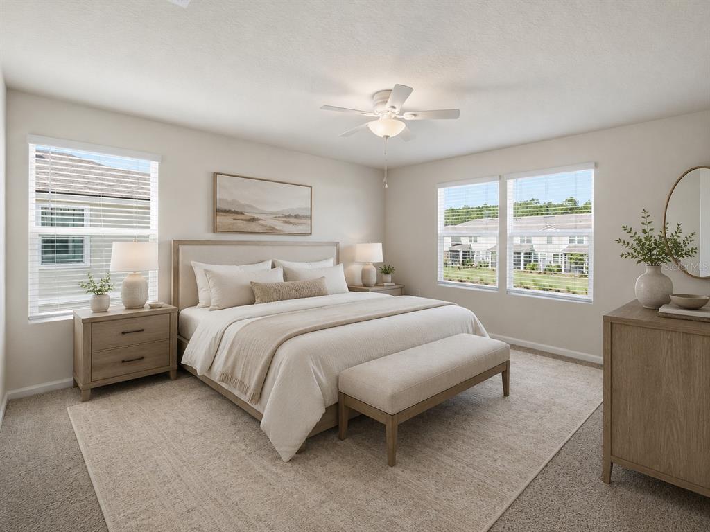 A neutral-toned bedroom features a king bed, matching nightstands, a bench, and two windows — 108 REDBUD ROAD, PALM COAST, FL