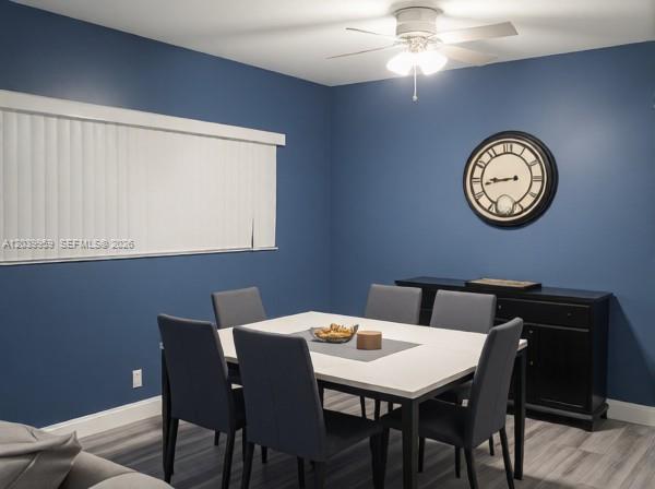 A dining room features blue walls, a white table with six chairs, and a ceiling fan — 2800 S University Dr # 0, Davie FL 33328, DAVIE, FL