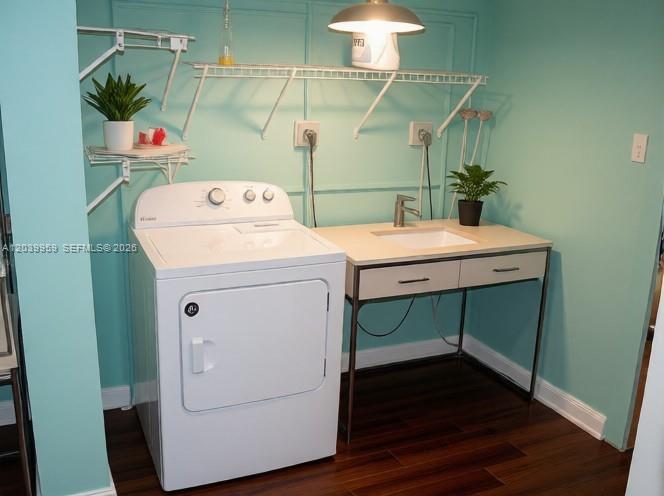 A laundry room features a white dryer, a sink vanity, and teal walls — 2800 S University Dr # 0, Davie FL 33328, DAVIE, FL